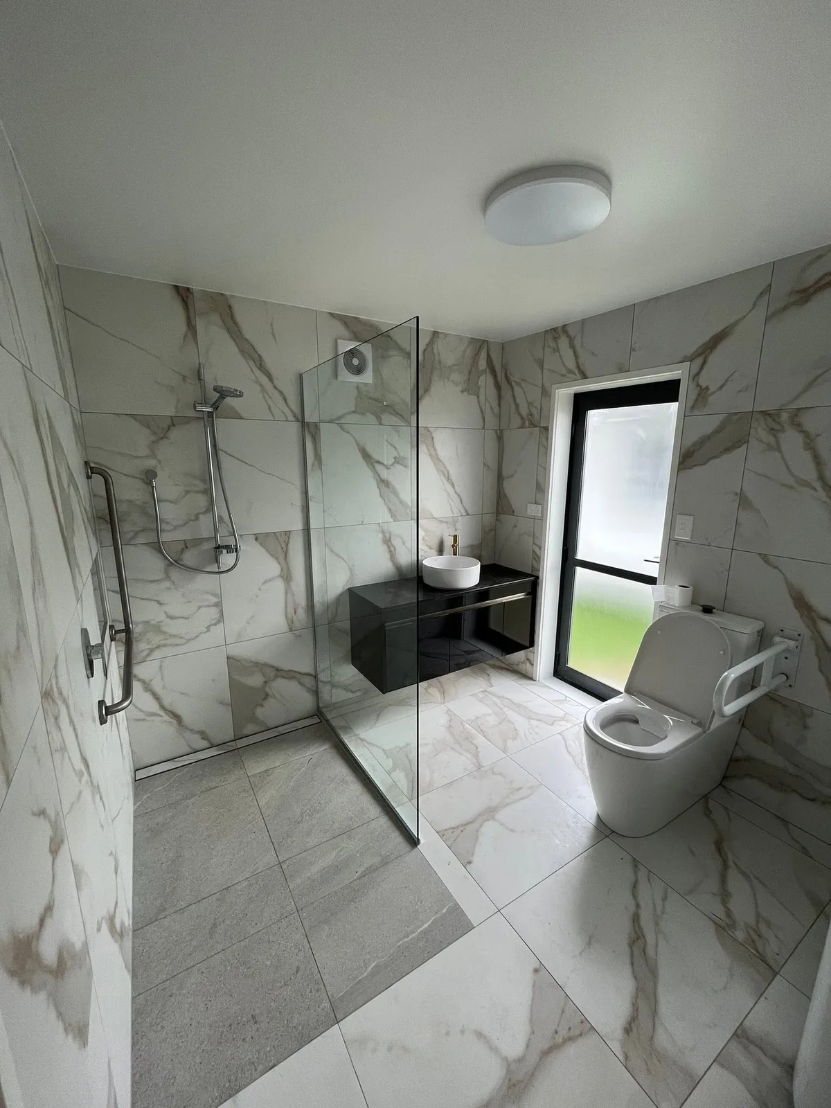 Completed marble-tiled ensuite with a walk-in shower
