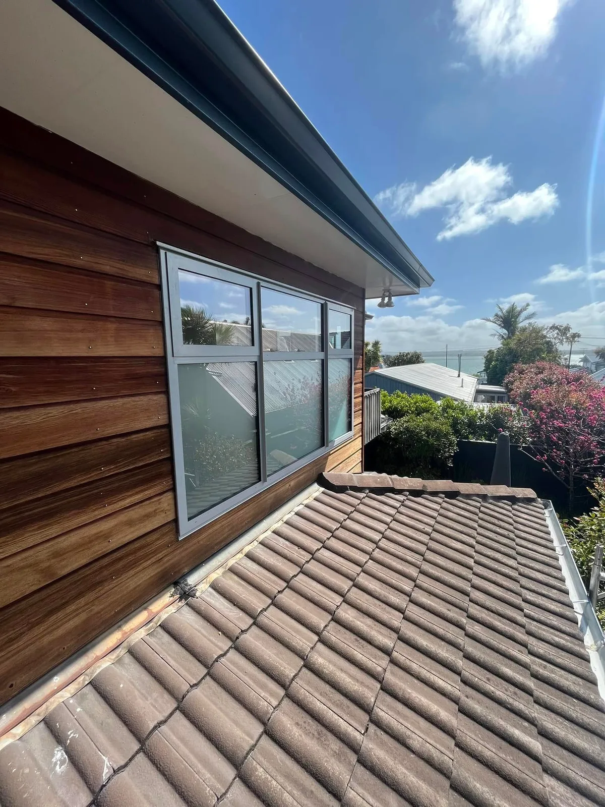 Newly installed window and cedar cladding overlooking the sea